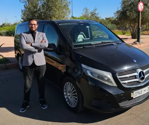 Private chauffeur standing beside a Mercedes V-Class in Marrakech